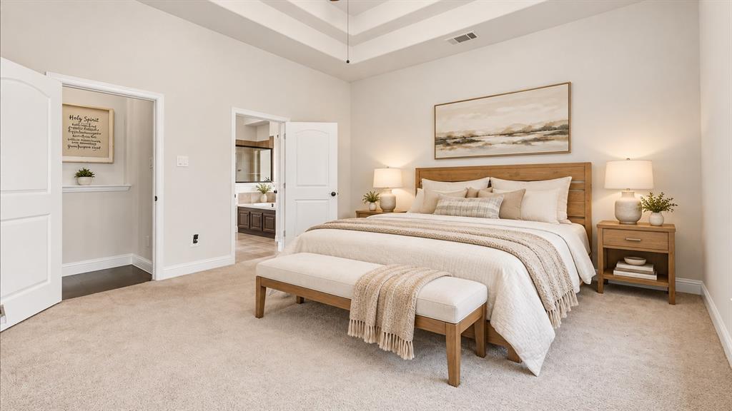 Spacious room featuring a tiered tray ceiling, neutral wall tones, plush wall-to-wall carpeting, and dual interior doors