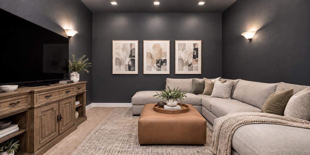Media room featuring dark-toned wall paint, recessed lighting, and wall-mounted sconces