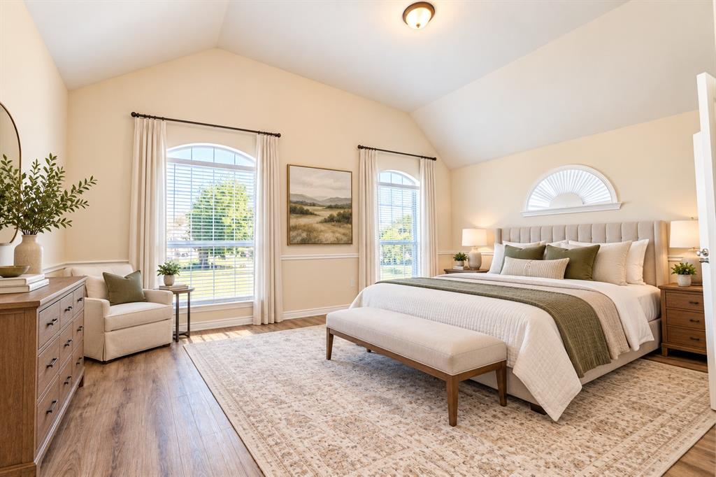 Vaulted ceilings, wood-look LVP flooring, chair rail molding, and arched windows.  *Virtually staged to show potential*