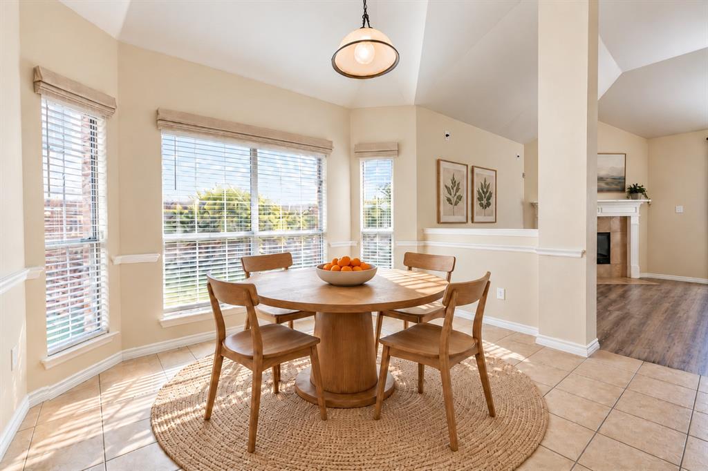 Vaulted ceilings, expansive multi-pane windows, ceramic tile flooring, and a pendant light fixture. *Virtually staged to show potential* Vaulted ceilings, expansive multi-pane windows, ceramic tile flooring, and a pendant light fixture. *Virtually staged to show potential*
