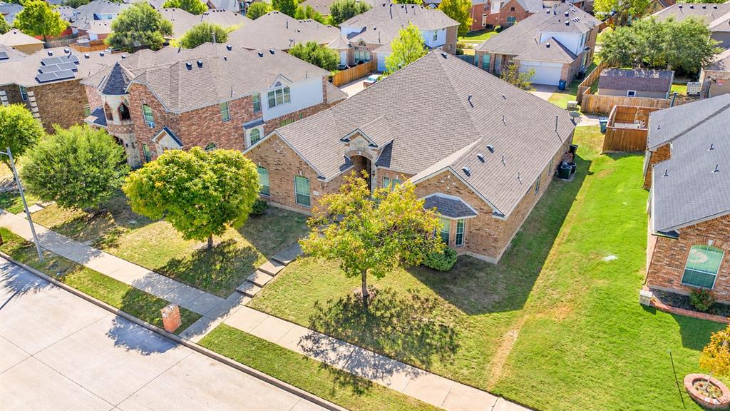 Single story brick exterior featuring architectural accents, and mature trees on an interior lot