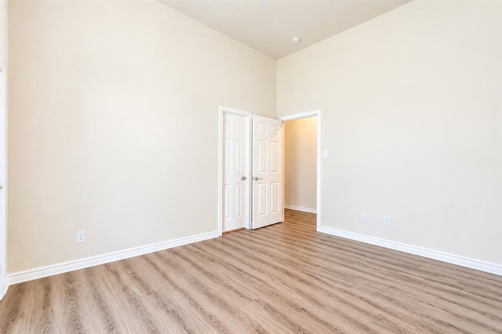 High ceilings, wood-look LVP flooring, and two interior panel doors