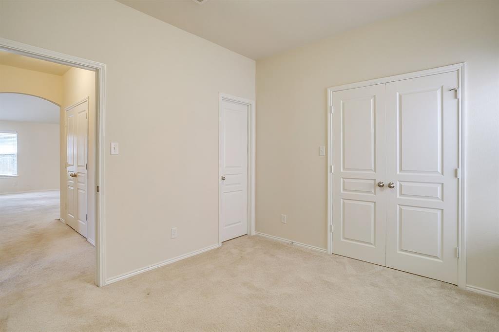 Neutral-toned carpeting, two-panel interior doors, and double-door closet entry