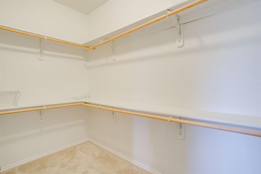 Storage area featuring dual-level hanging rods and integrated shelving units