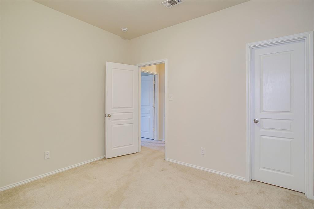 Neutral-toned interior featuring plush carpeting and multi-panel solid-core doors with satin nickel hardware