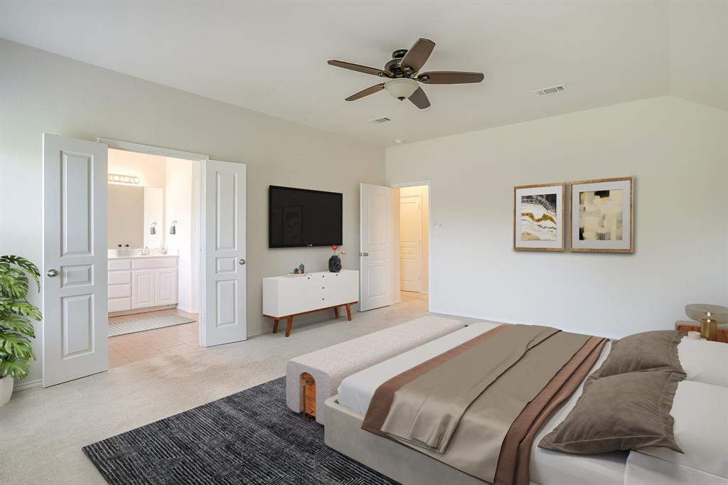 Neutral-toned bedroom featuring vaulted ceilings, carpeted flooring, a ceiling fan, and double panel doors