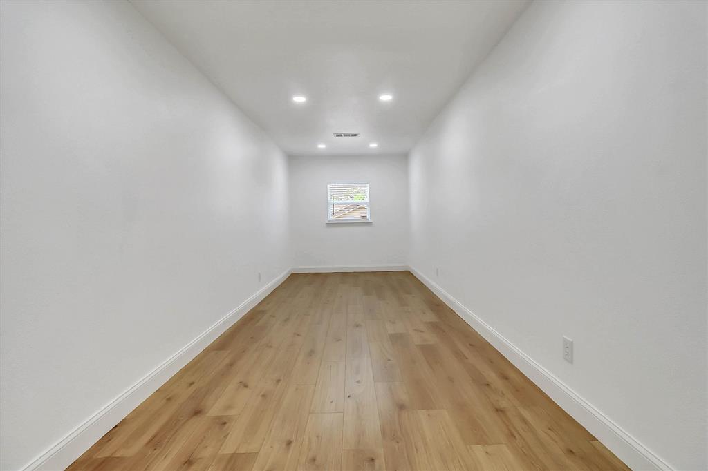 Interior room featuring wood-finish flooring, recessed lighting, and a single window