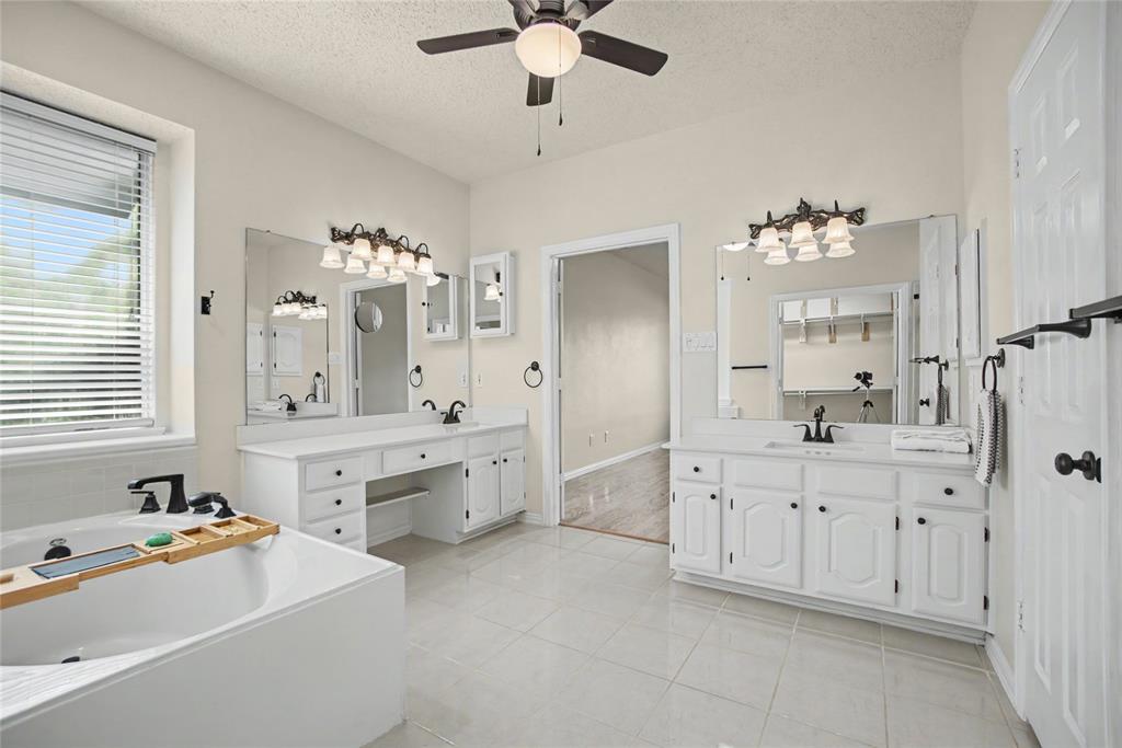 The remodeled Primary Bath is spa-like with marble counter tops, the shower has frameless glass door & romantic corner tub.