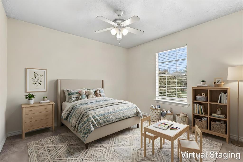 Neutral-toned interior space featuring wall-to-wall carpeting, a multi-pane window, and a central ceiling fan with integrated lighting