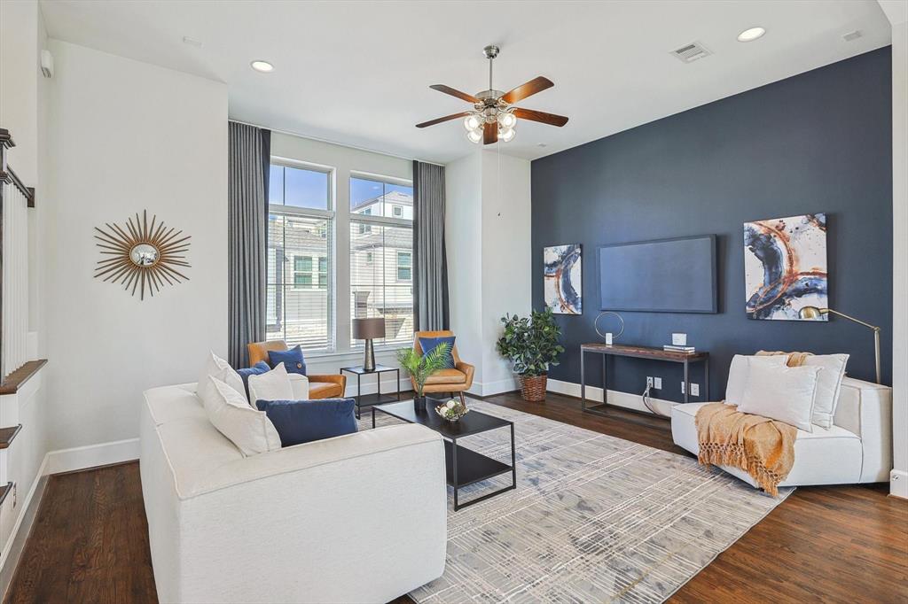 Living room with hardwood / wood-style floors and ceiling fan