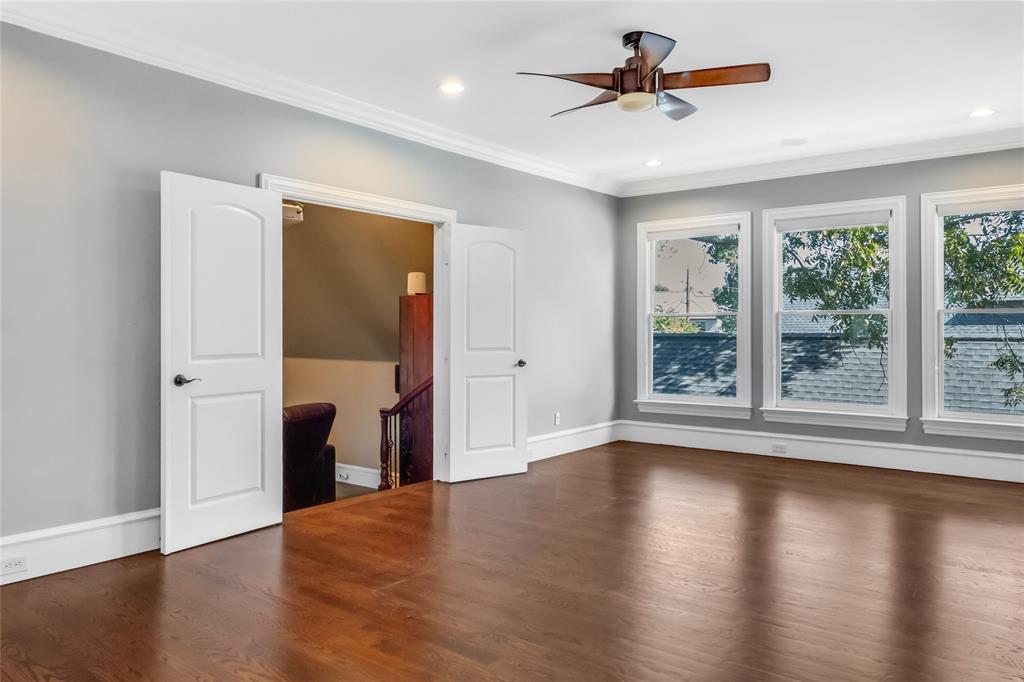 Room featuring wood-finish flooring, crown molding, recessed lighting, a ceiling fan, and double interior doors