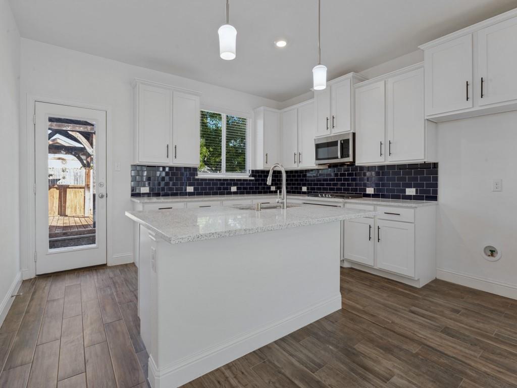 Large kitchen island offers additional workspace and a gathering spot for everyday living and entertaining.