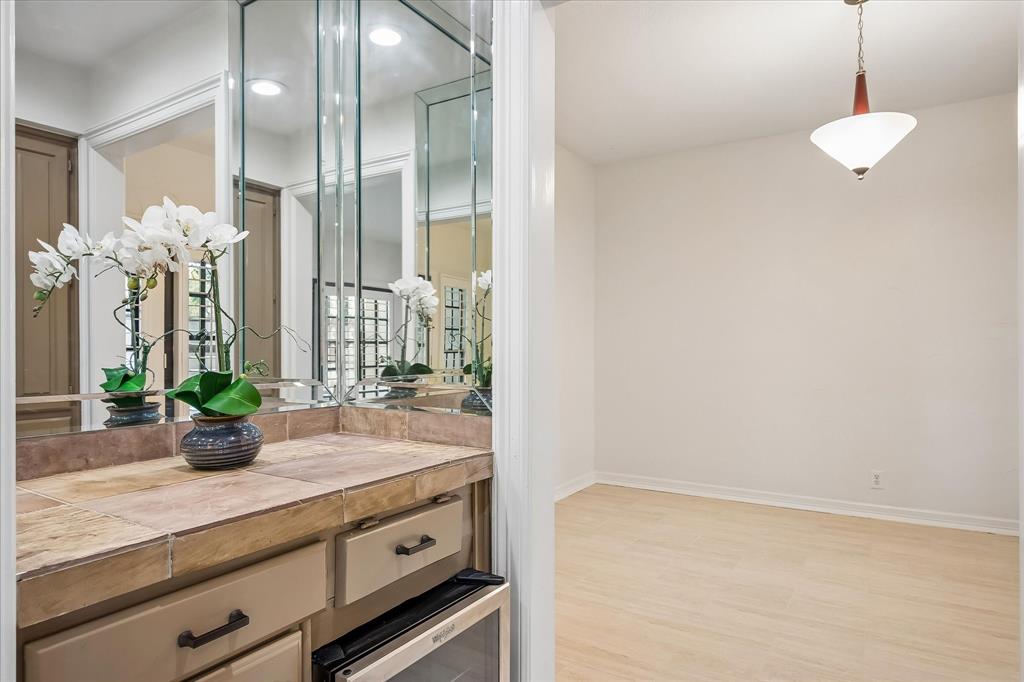 Dry Bar features a fridge and cabinetry