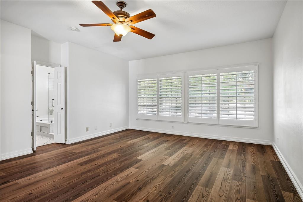 Room featuring VLP flooring, plantation shutters, and a ceiling fan with integrated lighting