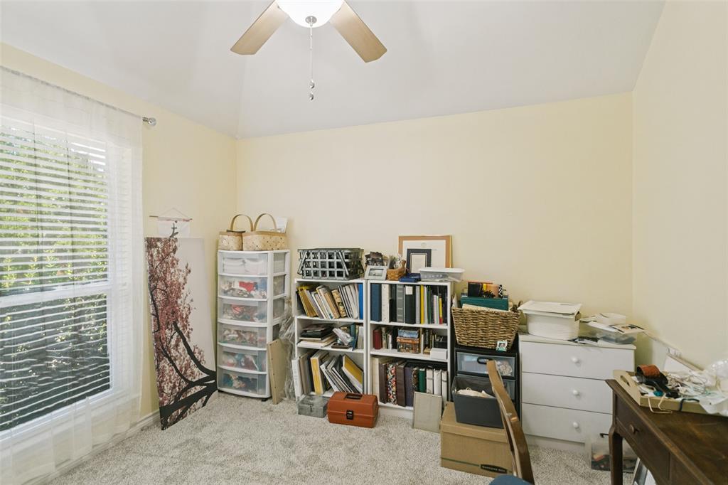 Vaulted ceiling featuring a central ceiling fan with integrated lighting and a large window with horizontal blinds