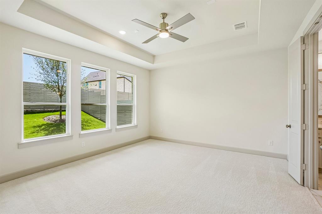 High ceilings, plush carpet and a wall of windows create a peaceful and relaxing owner's suite.