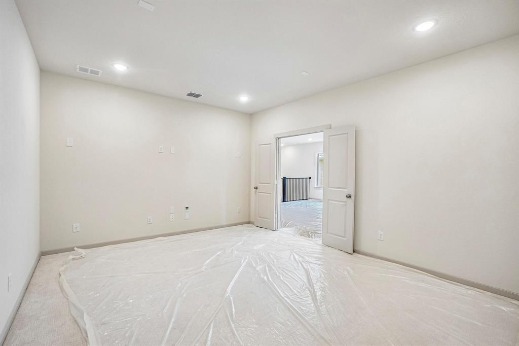 This spacious media room paired with adjacent game room create the ultimate family entertainment zone!