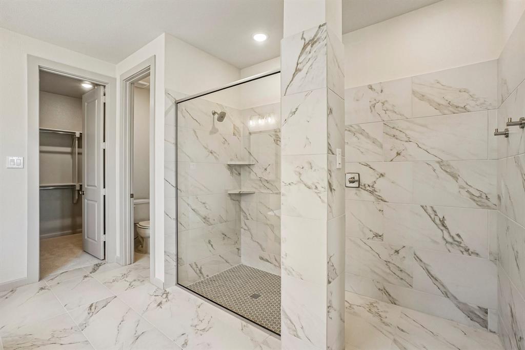 This dream owner's bath features a spacious walk in shower with drying area!