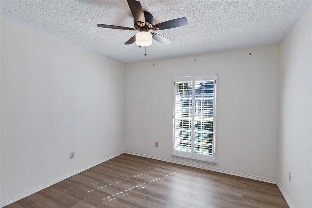 Secondary Bedroom with natural light, new ceiling fan and closet.