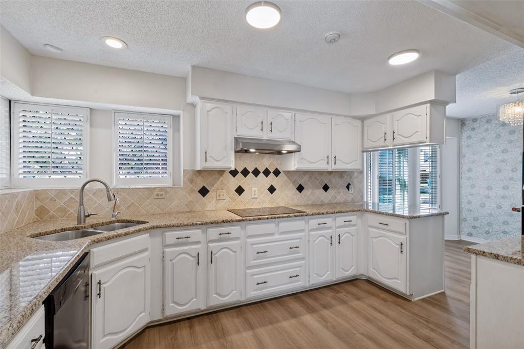 Kitchen with induction cooktop and Bosch dishwasher has a view from sink area.