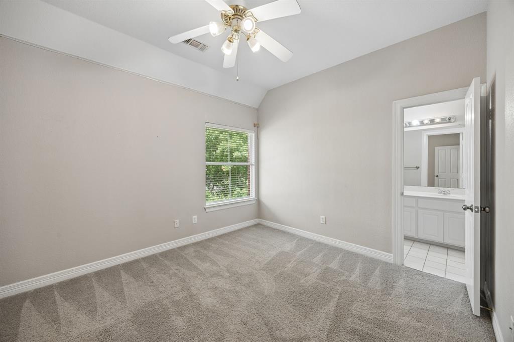Room featuring high tray ceilings, neutral wall tones, plush wall-to-wall carpeting, and a ceiling fan with multi-light fixture