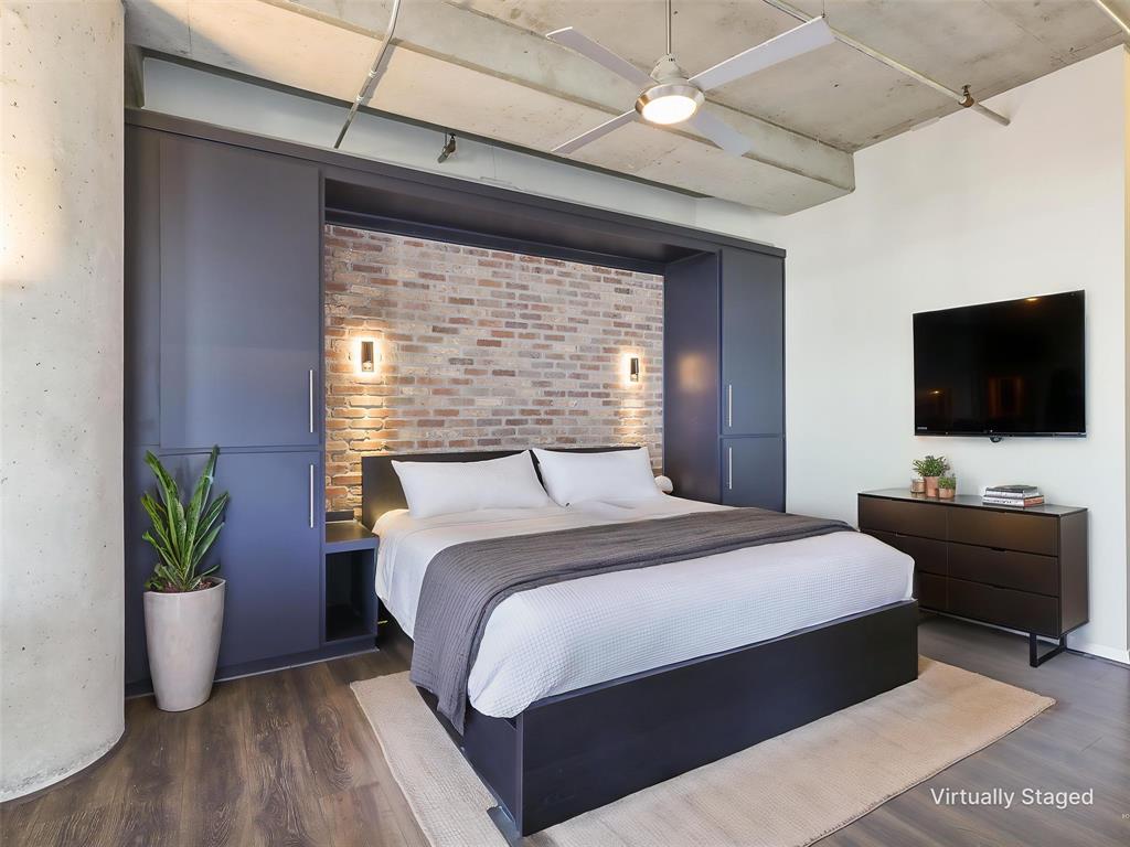 Primary Bedroom with built-in’s brick accent wall,and reading lights