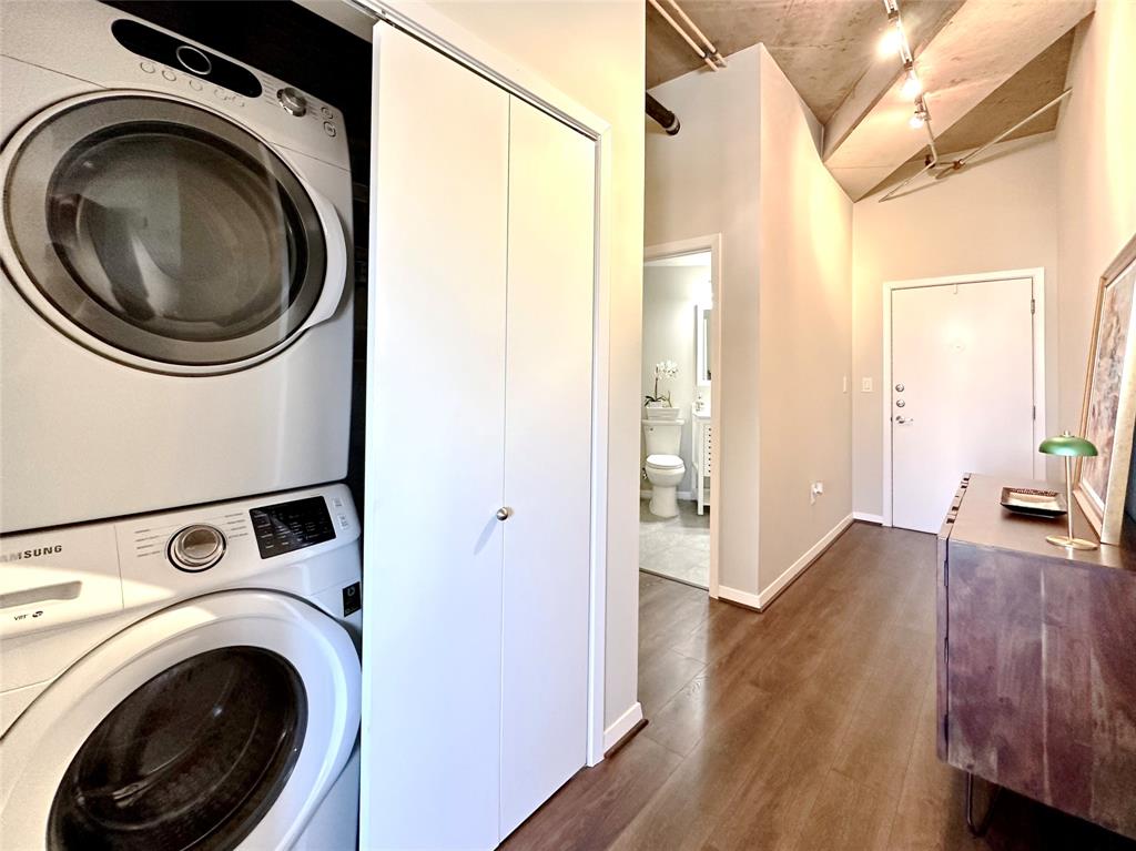 Stacked washer and dryer are located here inaddition to a large pantry with shelving