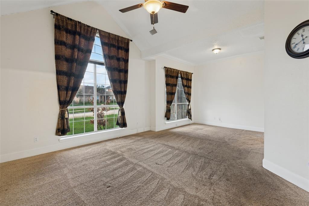 Vaulted ceilings, large grid windows, and a ceiling fan with integrated lighting Vaulted ceilings, large grid windows, and a ceiling fan with integrated lighting