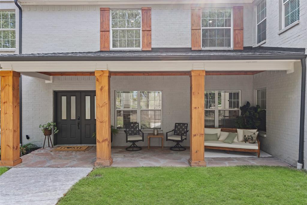 Inviting cedar wrapped covered front porch perfect for a morning coffee.