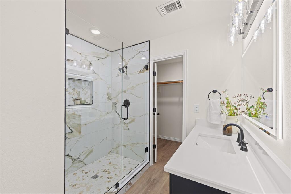 Primary bathroom with dual vanity and stand alone shower