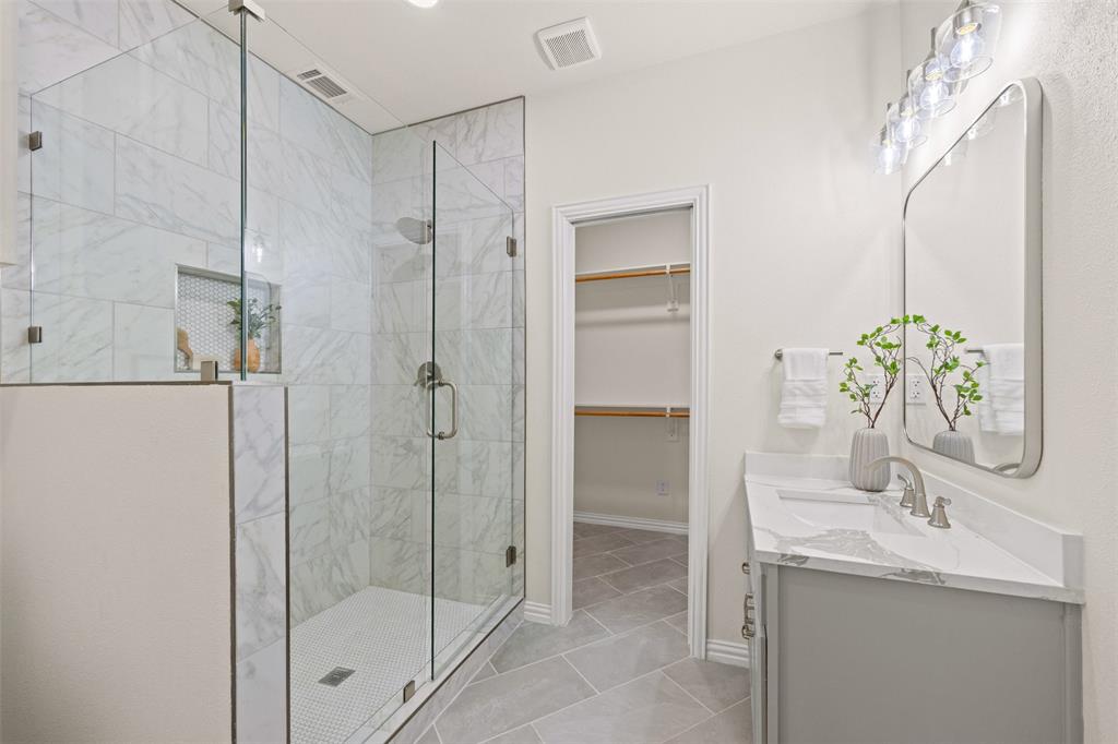 Bathroom with large walk in closet