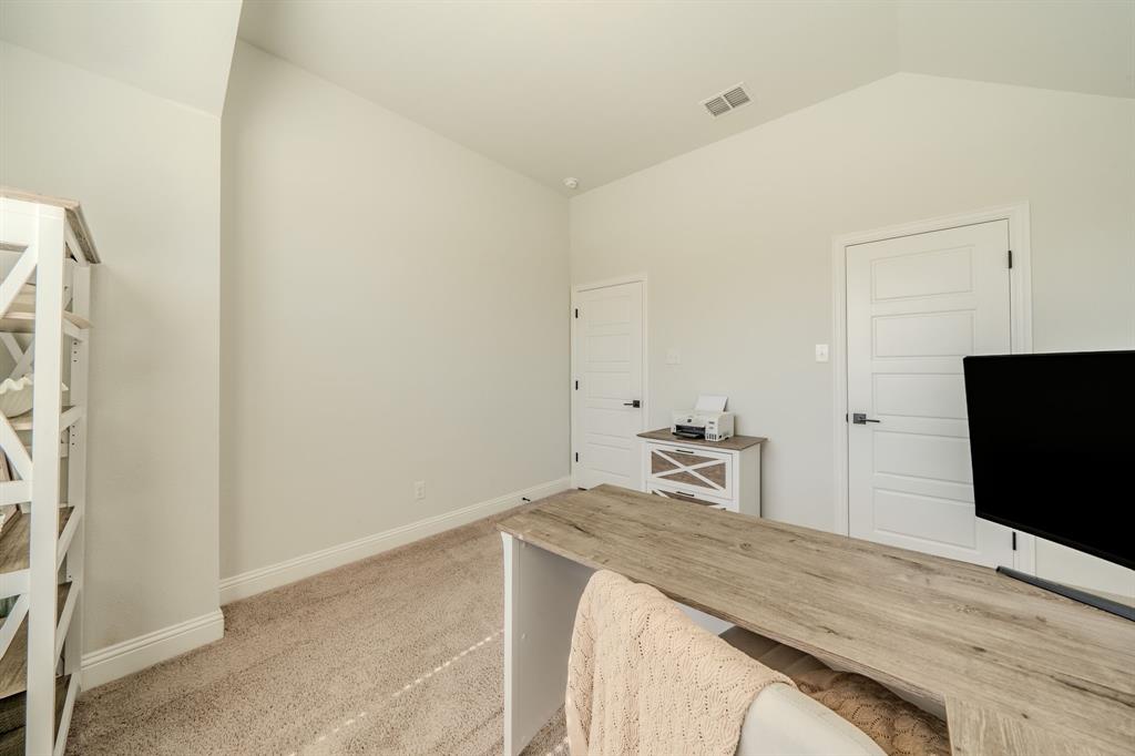 Vaulted ceiling, neutral wall tones, and interior doors with a four-panel horizontal design