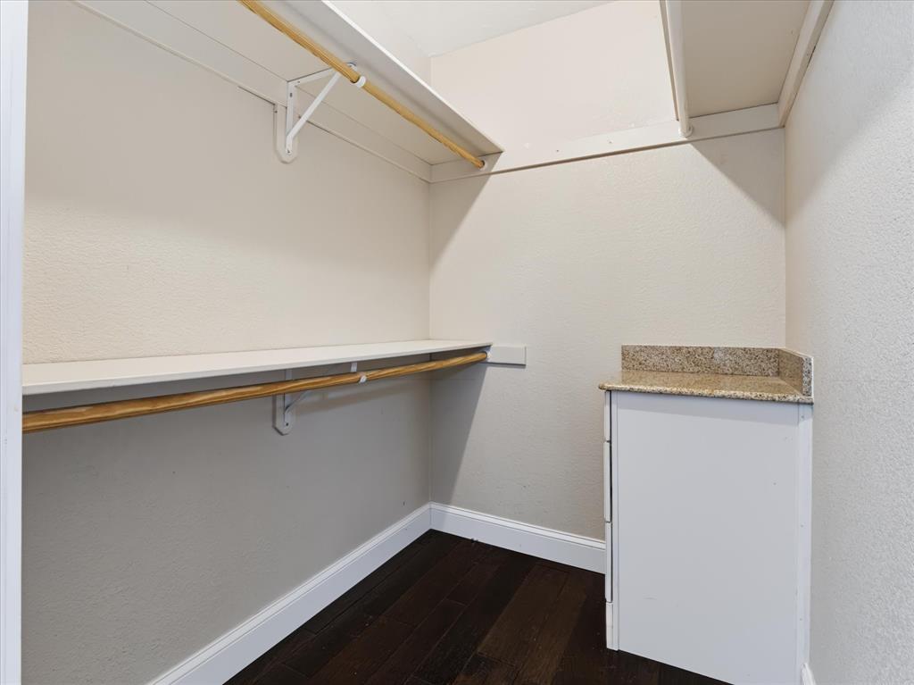 Primary Bedroom Walk in closet with built in dresser drawers
