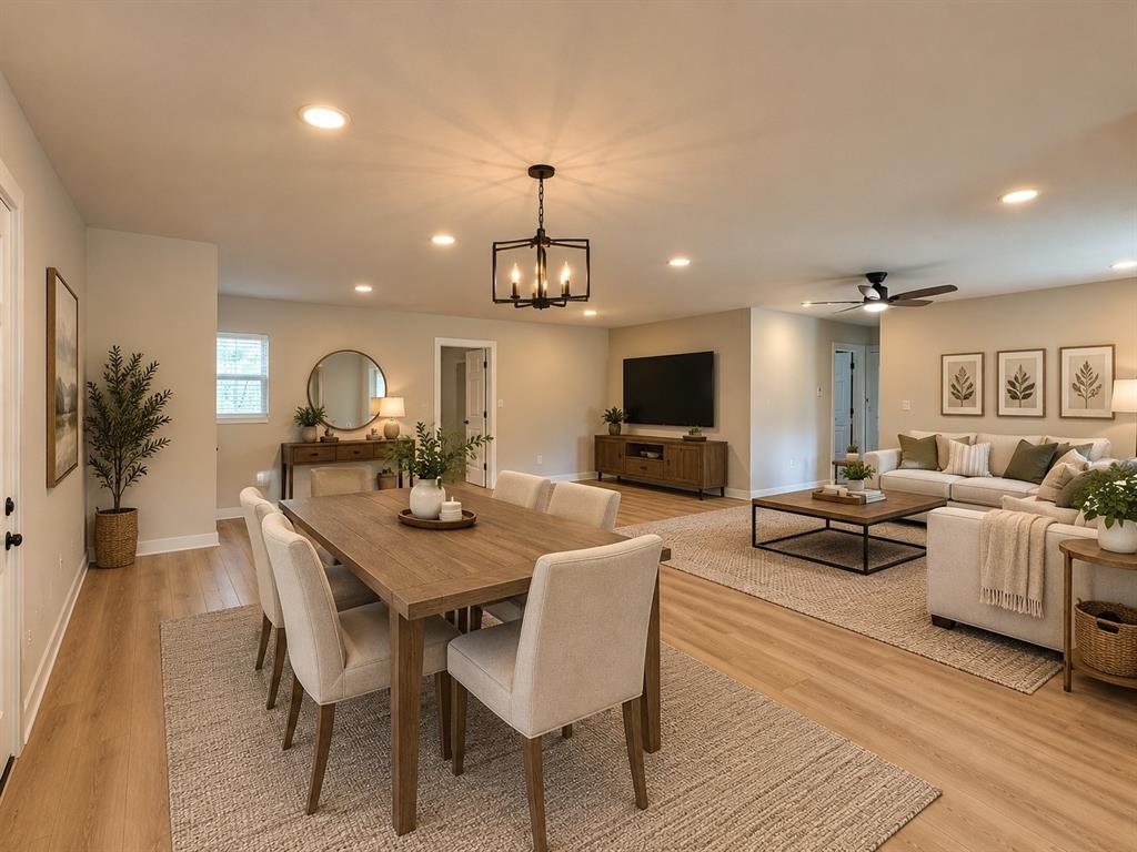 Open-concept floor plan featuring wood-finish flooring, recessed lighting, matte black geometric chandelier, and ceiling fan