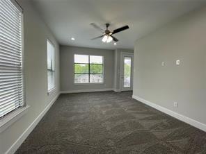 Neutral-toned interior featuring wall-to-wall carpeting, recessed lighting, a ceiling fan, and multi-pane windows