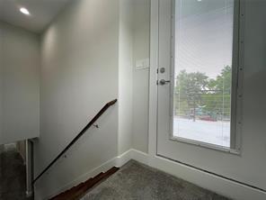 Full-lite exterior door with integrated blinds, recessed lighting, and wall-mounted handrail