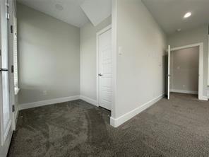 Neutral-toned interior featuring wall-to-wall carpeting, recessed ceiling lighting, and solid-core interior doors