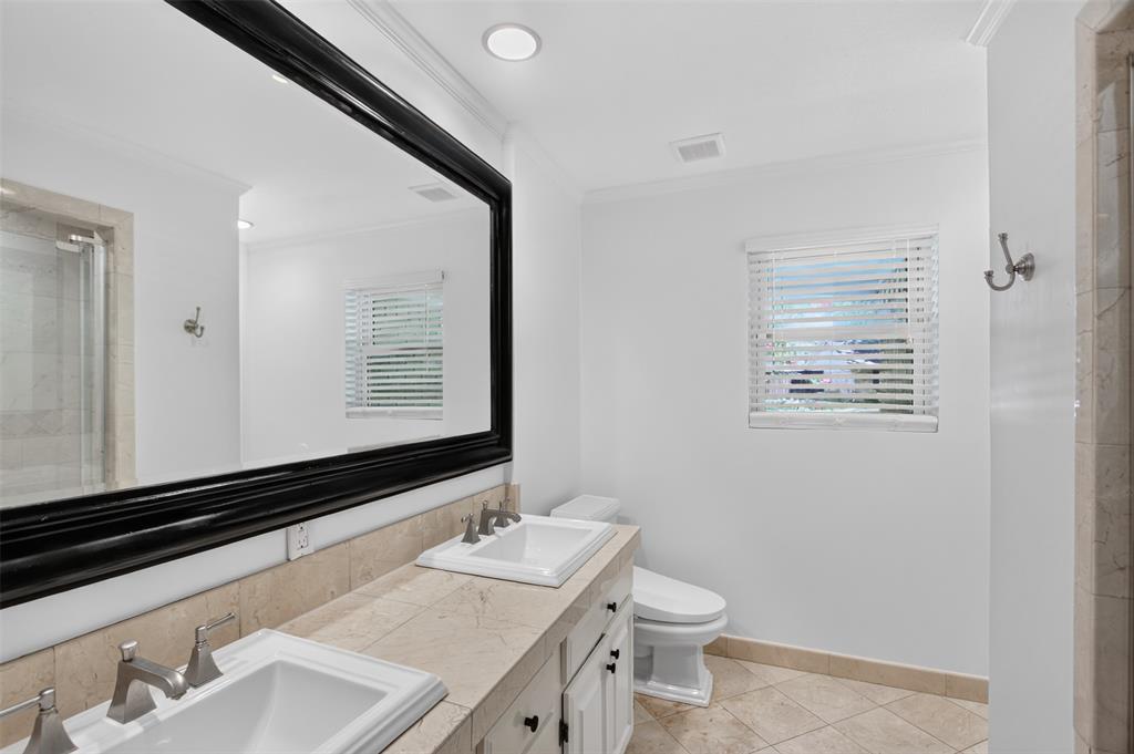 Full size bathroom adjacen to the bedrooms. Dual sinks, oversized walk in shower, tile floor, tile counter tops and so many cabinets. Floor to ceiling linen closet behind the door and updated Bidet. Bathroom freshly painted August 2026