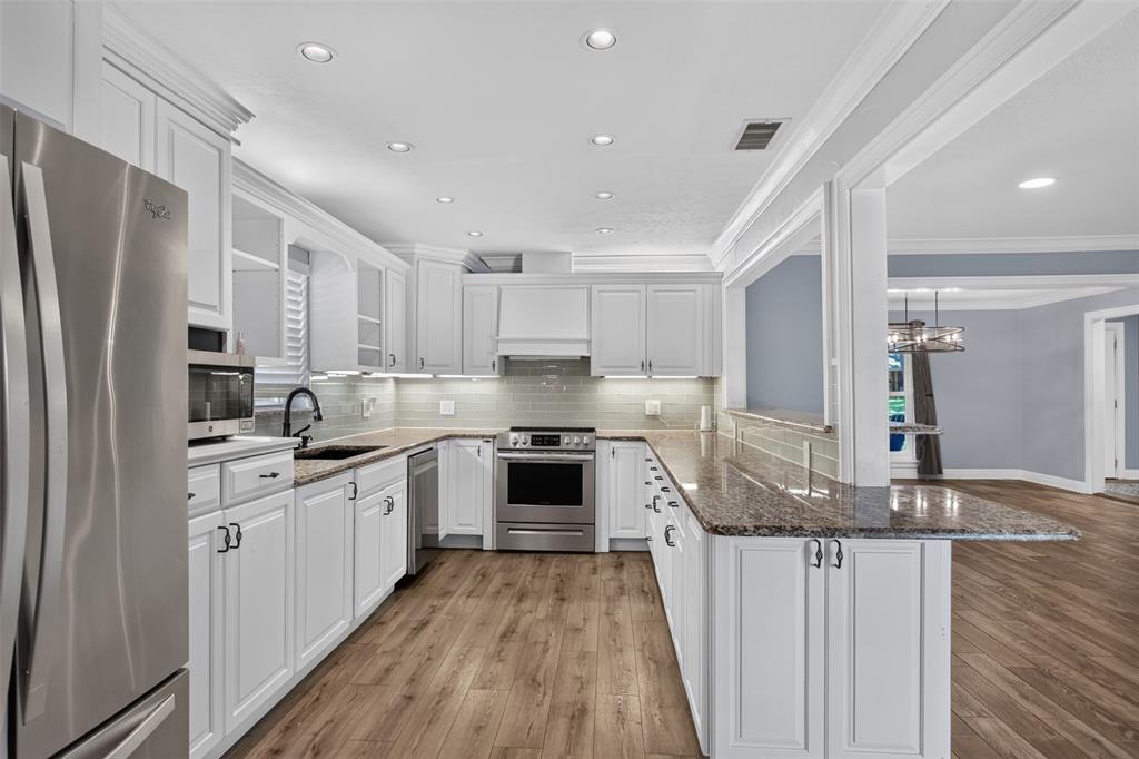 The kitchen features a thoughtful blend of open and closed cabinets, giving you opens of both display space and convenient storage. Abundance of counter space for meal prep and entertaining. Who would not love all these cabinets?