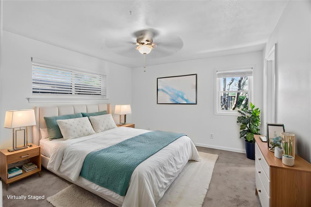 One of 3 bedrooms. Nice size, lots of window for natural light. Full size closet, ceiling-fan light fixture. August 2026 walls freshly painted. Rear door access to Jack N Jill bath. Wiindows look out on to gated private back yard.