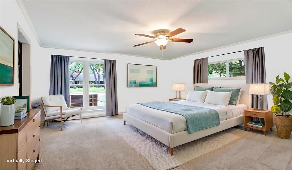 Spacious primary bedroom faces the front of the house. New Vinyl low E windows. Lots of natural light. Carpeted, ceiling-fan light fixture. Room has one full size closet with an additional closing off the dressing-make-up room. August 2026 walls freshly painted.