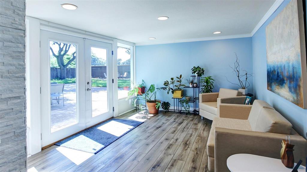 Enjoy the bright and airy sunroom with floor to ceiling windows and access to your private oversized backyard. Flooded with natural light, this flexible space can easily transform into a cozy reading room, plant lovers retreat, exercise or play room, even a home office.