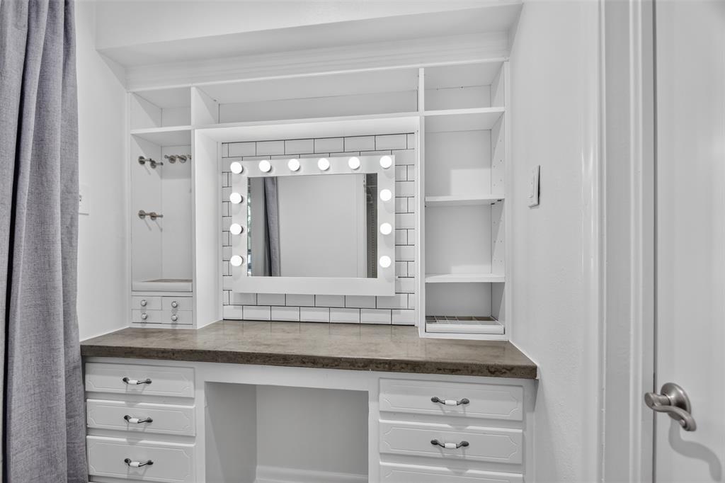 Just off the primary bath is a convenient dressing and make-up area offering extra storage and organization space, complimented by a full size closet directly across the hall.