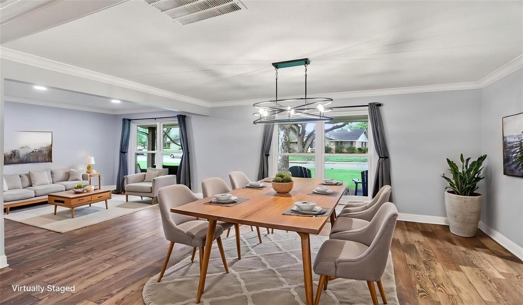 The dining area is part of an open floor plan that flows effortlessly into the living room and kitchen, providing a bright and functional space ideal for everyday living and entertaining. Updated light fixture adds to the warmth of the room.   12 x 10 room at the front is a great flex area, another seating room, home office, etc. Homeowners installed recessed lighting.