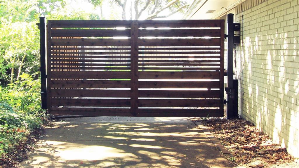 Sellers updated the security gate with remote controls and new wood. Front entrance and backyard driveway has space for additional parking.