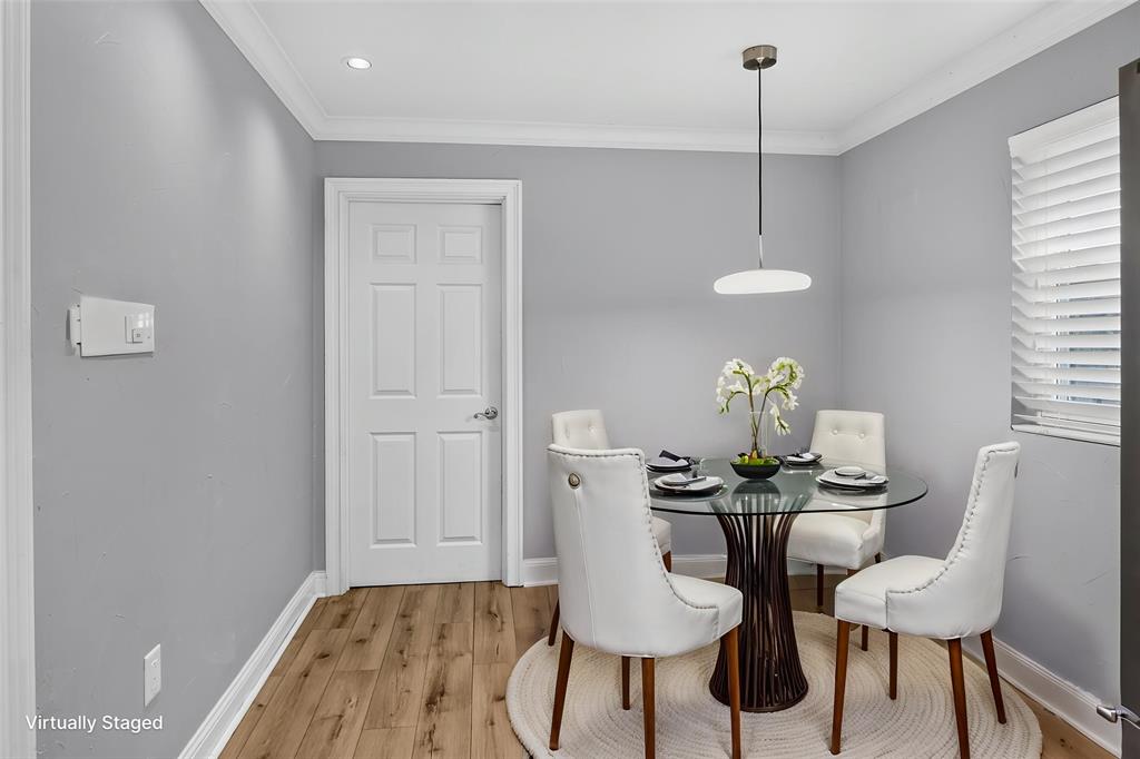Breakfast area is 9 x 7 with wood look vinyl floors, window and access door to the full size Utility room and inside garage entrance. Updated light fixture