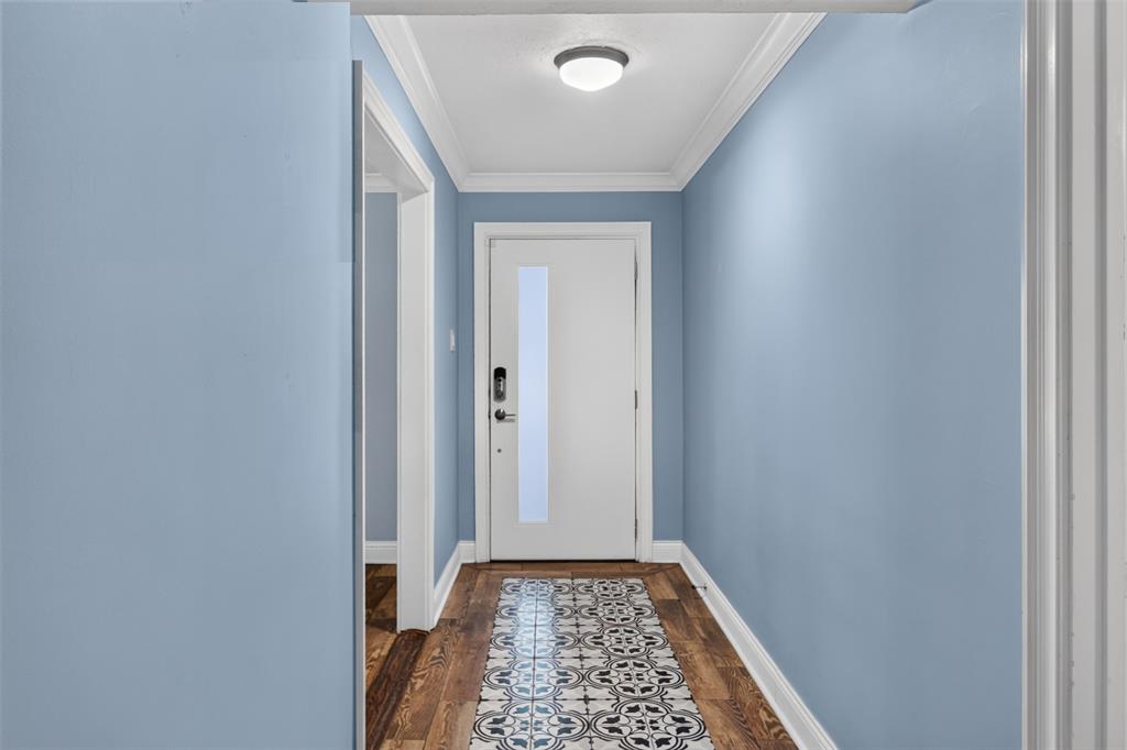 Love the mosaic inlaid tile foyer. Paint color brings out the blue in- the floor tiles. Note: walls had all texture removed and freshly painted for a smoother look. Redid transition pieces 2024.
