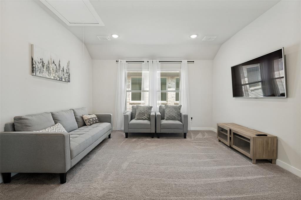 Neutral-toned interior featuring a vaulted ceiling, recessed lighting, and wall-to-wall carpeting Neutral-toned interior featuring a vaulted ceiling, recessed lighting, and wall-to-wall carpeting