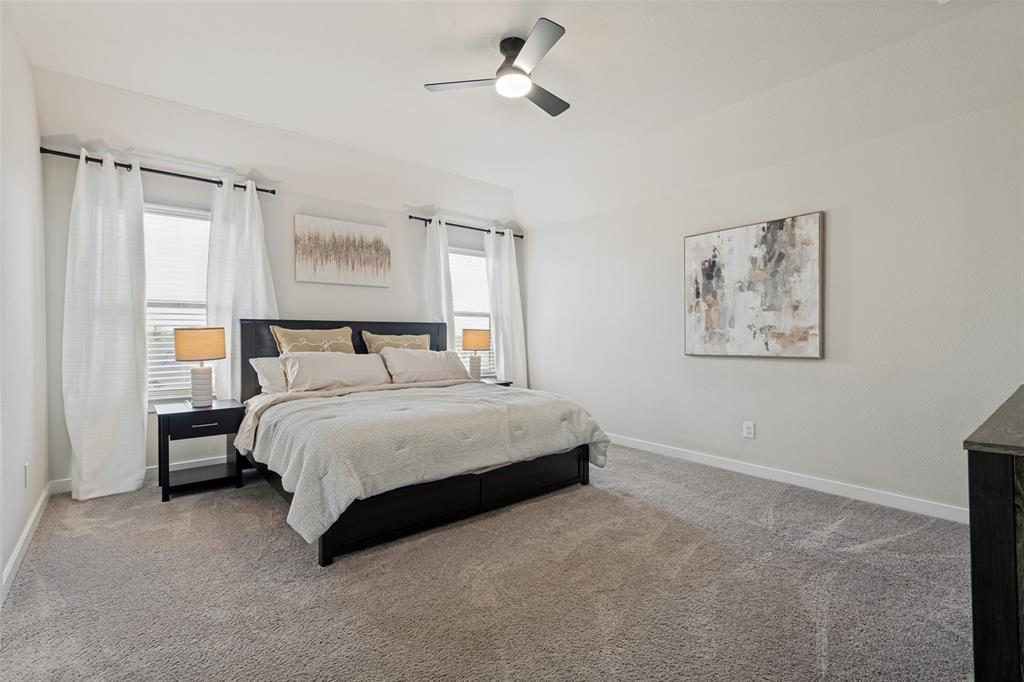 Vaulted ceilings, neutral carpeting, dual windows, and an integrated ceiling fan with light fixture Vaulted ceilings, neutral carpeting, dual windows, and an integrated ceiling fan with light fixture