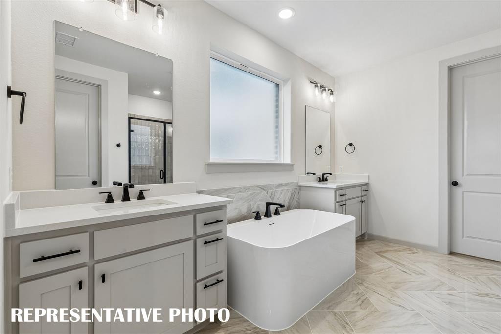 Filled with style and offering plenty of room for two, this owner's bath is the perfect place to start or end your day!  REPRESENTATIVE PHOTO